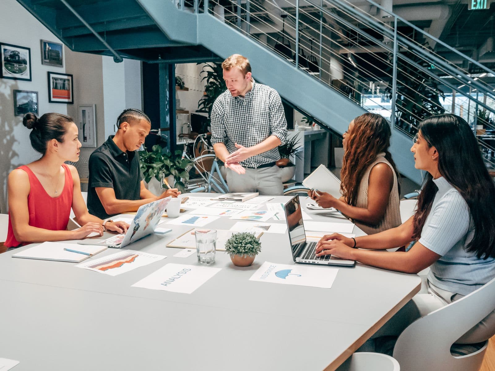 Team reviewing documents and data around an office table