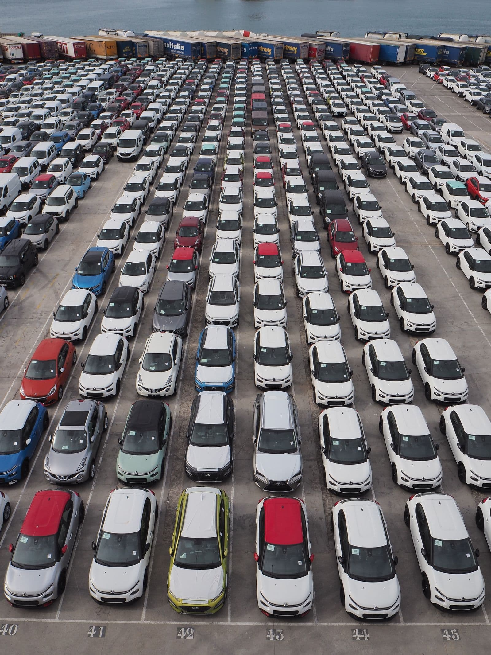 Rows of vehicles in a large automotive inventory yard